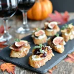 Brie apple fig crostini appetizer on slate tray