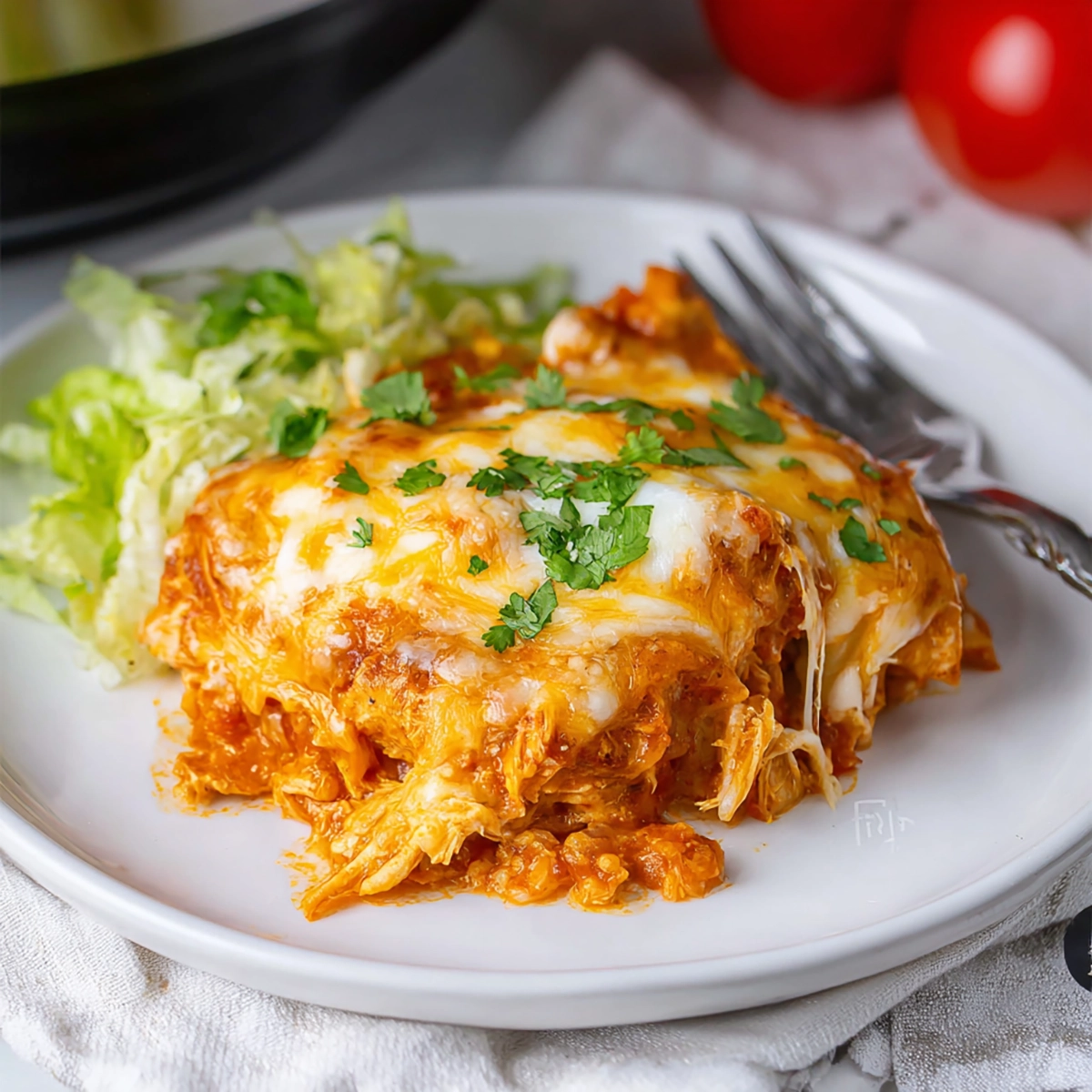 Overhead view of Crockpot Chicken Enchilada Casserole ingredients arranged on wooden board in glass bowls
